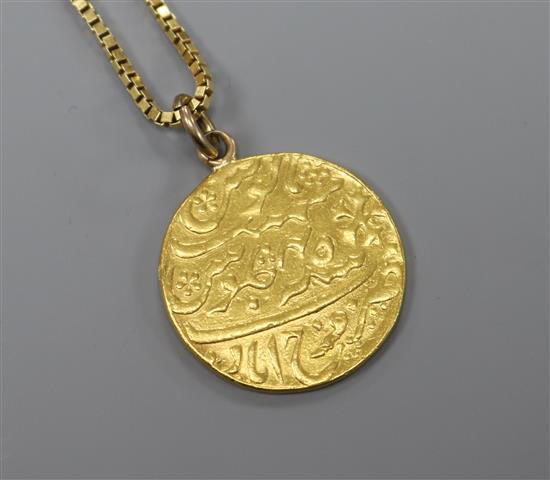 A Persian yellow metal coin mounted as a pendant on a 9ct gold chain.